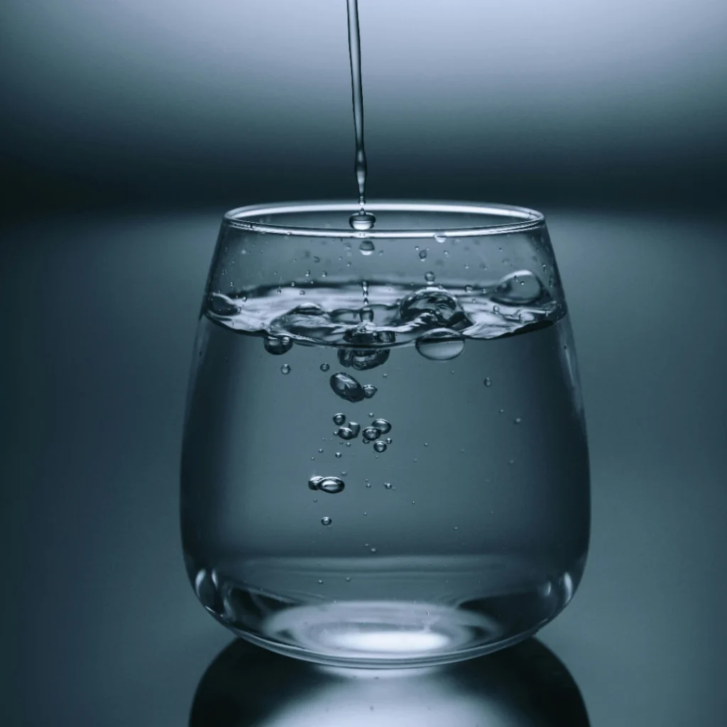 Transparent glass with pouring water in the Masking Transparent Objects Photo Editing article in Dropicts.com