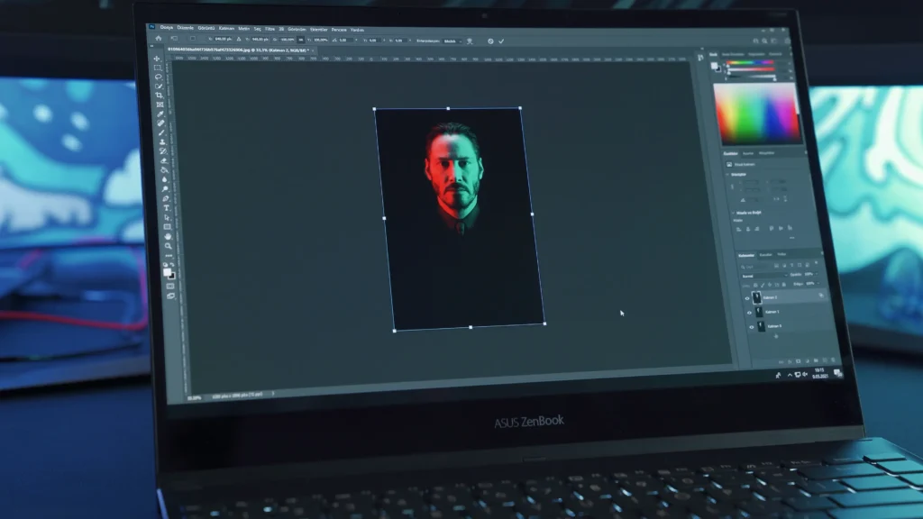 A close-up view of an ASUS ZenBook laptop screen open to photo editing software (Adobe Photoshop), showing a dramatic portrait of a man lit with red and green dual lighting against a dark background. This image is located in "Pay as You Go Photo Editing Service" article in Dropicts.com website.