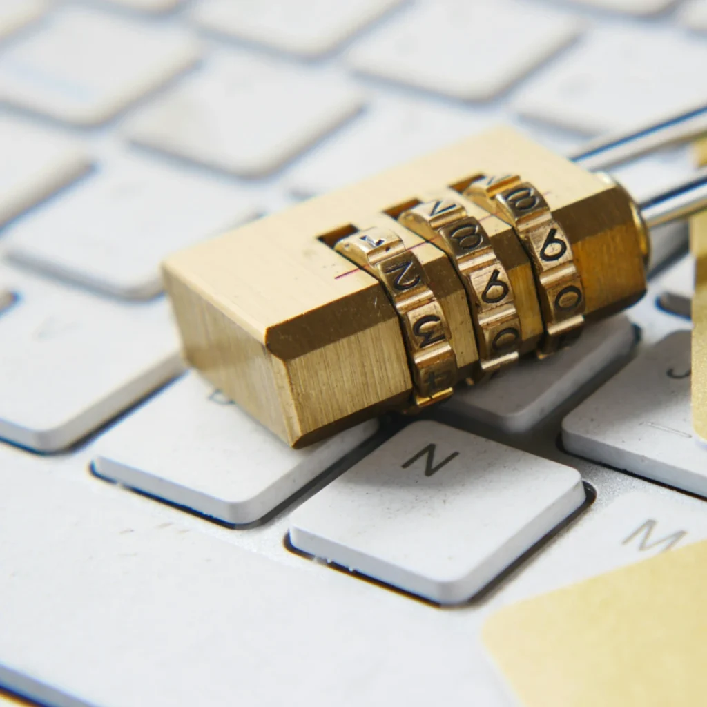 A gold padlock on top of a white keyboard in "Photo Editing Service Data Security" article in Dropicts.com website