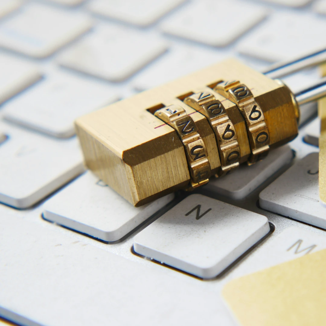 A gold padlock on top of a white keyboard in "Photo Editing Service Data Security" article in Dropicts.com website