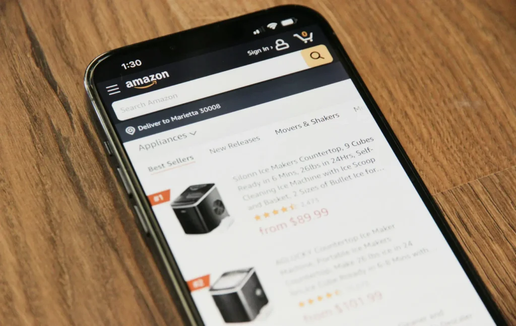 A close-up of a smartphone screen showing the Amazon app, which displays a list of best-selling appliances including a Silonn countertop ice maker. This image is included in the "Product Images for AI Shopping Agents" article in Dropicts.com website