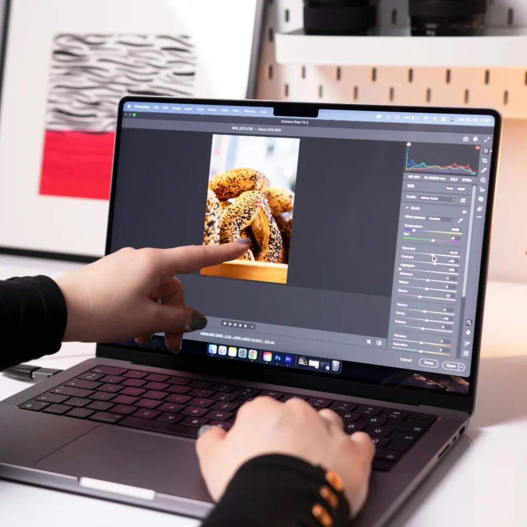 Human finger pointing to the laptop screen in the Reshoot vs Edit Product Photo article in Dropicts.com